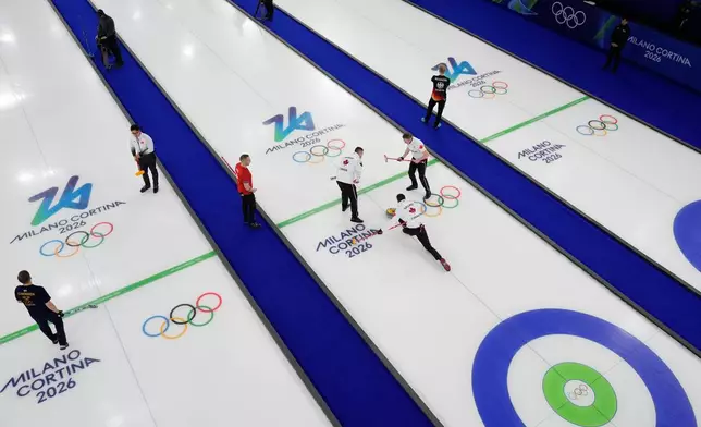 Canada's Ben Hebert, Brett Gallant and Marc Kennedy compete during a men's curling round robin match against Switzerland at the 2026 Winter Olympics, in Cortina d'Ampezzo, Italy, Saturday, Feb. 14, 2026. (AP Photo/David J. Phillip)