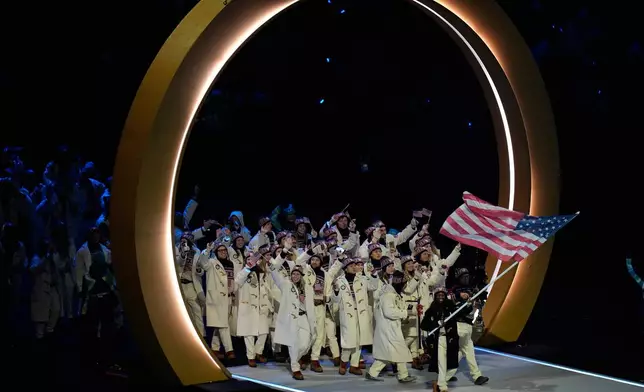 United States' flag barer Erin Jackson arrives during the Olympic opening ceremony at the 2026 Winter Olympics, in Milan, Italy, Friday, Feb. 6, 2026. (AP Photo/Hassan Ammar)