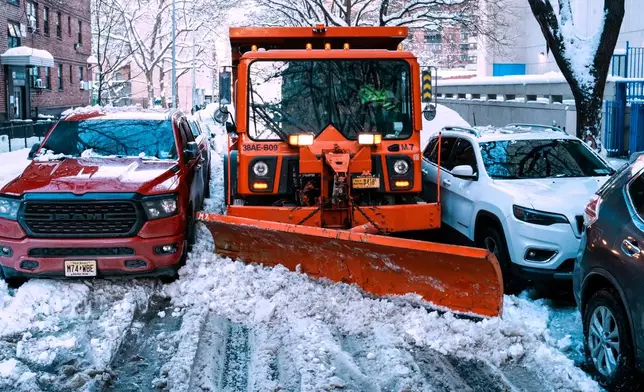 A truck removes snow for them street a day after a winter storm on Tuesday, Feb. 24, 2026, in New York. (AP Photo/Eduardo Munoz Alvarez)