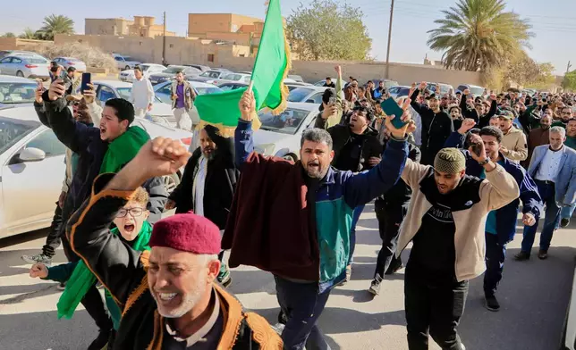 Libyans march to attend the funeral of Seif al-Islam, son of then Libyan Leader Moammar Gadhafi, in Bani Walid city, Libya, Friday, Feb. 6, 2026. (AP Photo/Yousef Murad)
