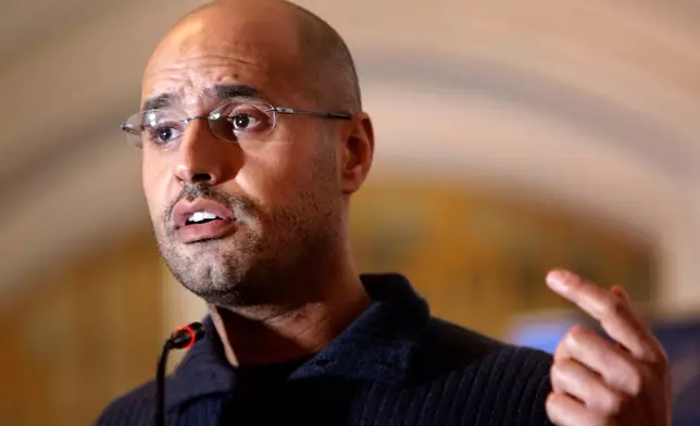 FILE - In this Feb. 25, 2011, file photo, Seif al-Islam Gadhafi speaks to the media at a press conference in a hotel in Tripoli, Libya. (AP Photo/Ben Curtis, File)