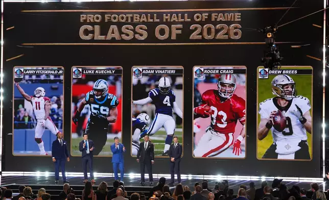 Pro Football Hall of Fame Class of 2026 Larry Fitzgerald, Luke Kuechly, kicker Adam Vinatieri, Roger Craig and Drew Brees stand of stage during the NFL Honors award show, Thursday, Feb. 5, 2026, in San Francisco. (AP Photo/Charlie Riedel)