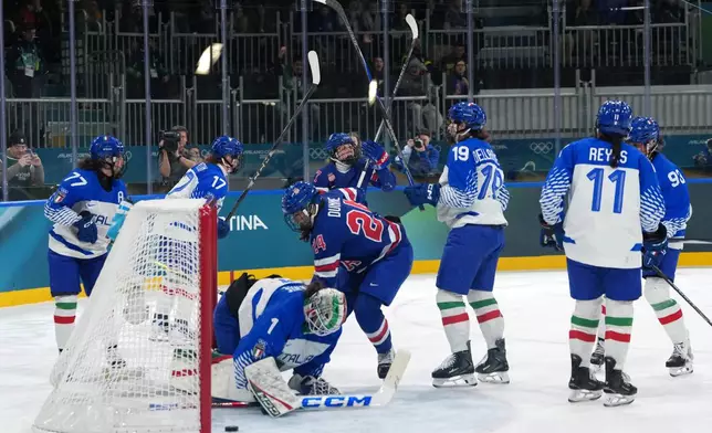 Team United States players celebrate after a goal by Britta Curl, center top, during the second period of a women's ice hockey quarterfinal match between the United States and Italy at the 2026 Winter Olympics, in Milan, Italy, Friday, Feb. 13, 2026. (AP Photo/Carolyn Kaster)