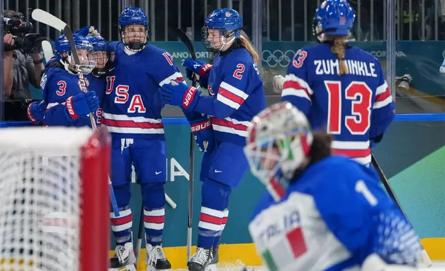 Team United States players celebrate a goal by Kendall Coyne, second from left, during the second period of a women's ice hockey quarterfinal match against Italy at the 2026 Winter Olympics, in Milan, Italy, Friday, Feb. 13, 2026. (AP Photo/Carolyn Kaster)
