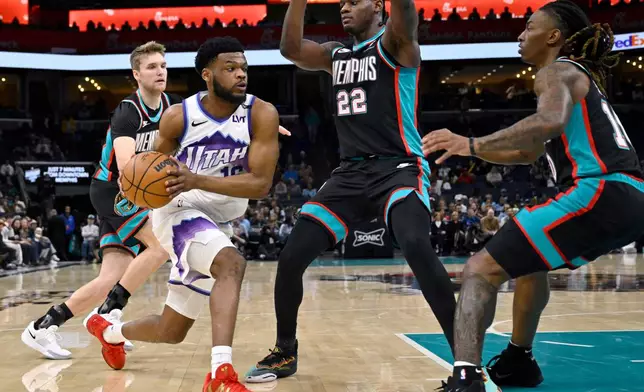 Utah Jazz guard Elijah Harkless, front left, handles the ball against Memphis Grizzlies guard Cam Spencer, back left, forward Taylor Hendricks (22) and guard Javon Small, right, in the first half of an NBA basketball game Friday, Feb. 20, 2026, in Memphis, Tenn. (AP Photo/Brandon Dill)