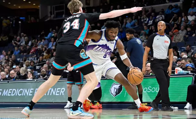 Utah Jazz guard Isaiah Collier (8) handles the ball against Memphis Grizzlies center Lawson Lovering (34) in the first half of an NBA basketball game Friday, Feb. 20, 2026, in Memphis, Tenn. (AP Photo/Brandon Dill)