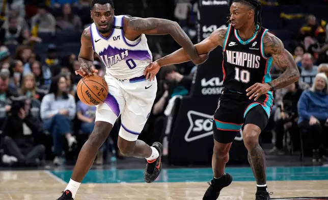 Utah Jazz guard Vince Williams Jr. (0) brings the ball upcourt against Memphis Grizzlies guard Javon Small (10) in the first half of an NBA basketball game Friday, Feb. 20, 2026, in Memphis, Tenn. (AP Photo/Brandon Dill)