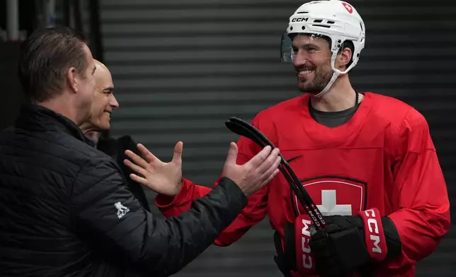 Switzerland's Roman Josi arrives for men's ice hockey practice at the 2026 Winter Olympics, in Milan, Italy, Sunday, Feb. 8, 2026. (AP Photo/Carolyn Kaster)