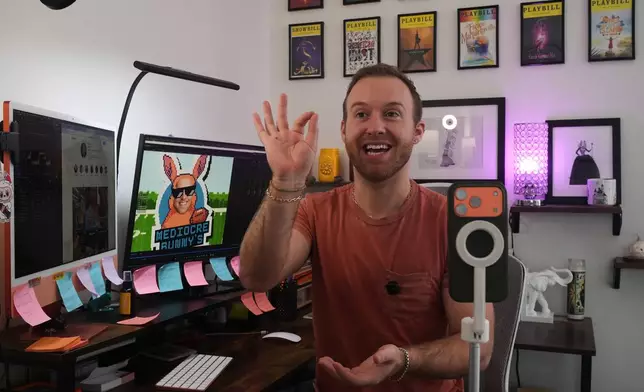 Niklaus Miller sits at his computer as he learns Bad Bunny's songs in preparation for Bad Bunny's Super Bowl halftime show at his home in the Hollywood section of Los Angeles Friday, Jan. 16, 2026. (AP Photo/Damain Dovarganes)
