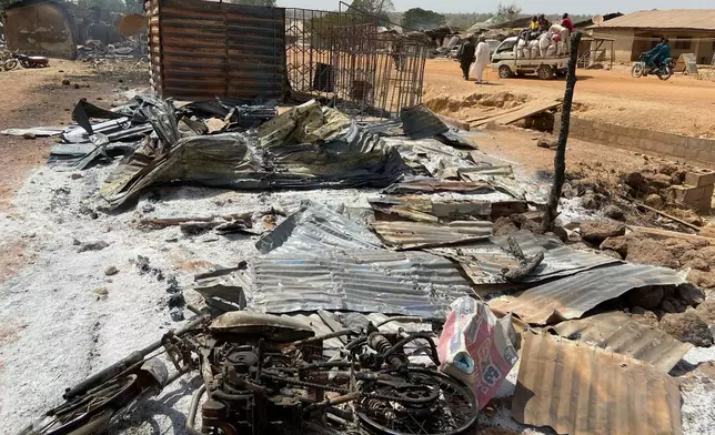Charred objects lay on the ground where homes and a market once stood, days after an attack in the village of Woro, Nigeria, Thursday, Feb. 5, 2026. (AP Photo/Musa Salim)