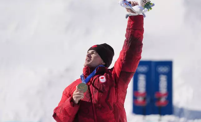 Gold medalist Canada's Mikael Kingsbury (4) celebrates after the men's freestyle skiing dual moguls finals at the 2026 Winter Olympics, in Livigno, Italy, Sunday, Feb. 15, 2026. (AP Photo/Gregory Bull)