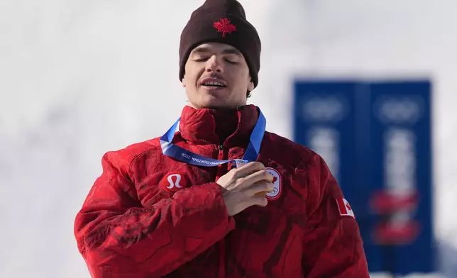 Gold medalist Canada's Mikael Kingsbury (4) celebrates after the men's freestyle skiing dual moguls finals at the 2026 Winter Olympics, in Livigno, Italy, Sunday, Feb. 15, 2026. (AP Photo/Gregory Bull)