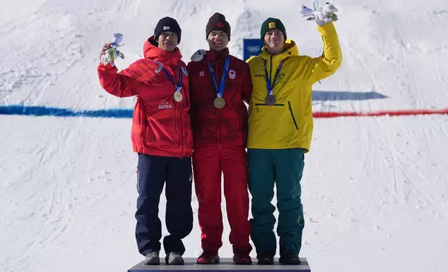 From left, silver medalist Japan's Ikuma Horishima (2), gold medalist Canada's Mikael Kingsbury (4), and bronze medalist Australia's Matt Graham (6) celebrate after the men's freestyle skiing dual moguls finals at the 2026 Winter Olympics, in Livigno, Italy, Sunday, Feb. 15, 2026. (AP Photo/Gregory Bull)