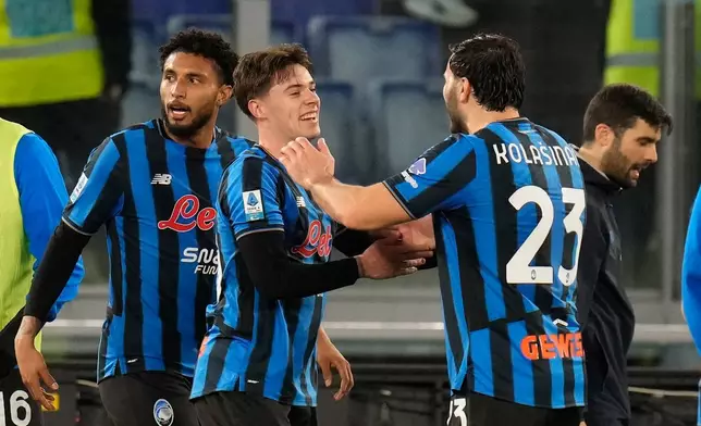Atalanta's Nicola Zalewski, centre, celebrates with his teammates after scoring his side's second goal during the Serie A soccer match between Lazio and Atalanta in Rome, Saturday, Feb. 14, 2026. (AP Photo/Gregorio Borgia)