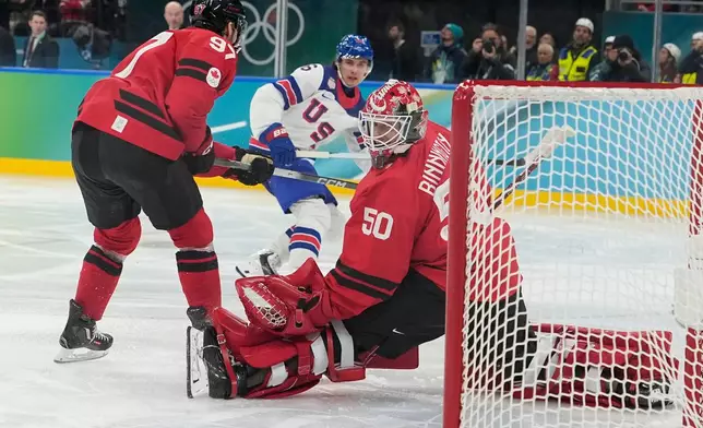 United States' Jack Hughes (86) scores during a men's ice hockey gold medal game between Canada and the United States at the 2026 Winter Olympics, in Milan, Italy, Sunday, Feb. 22, 2026. (AP Photo/Hassan Ammar)