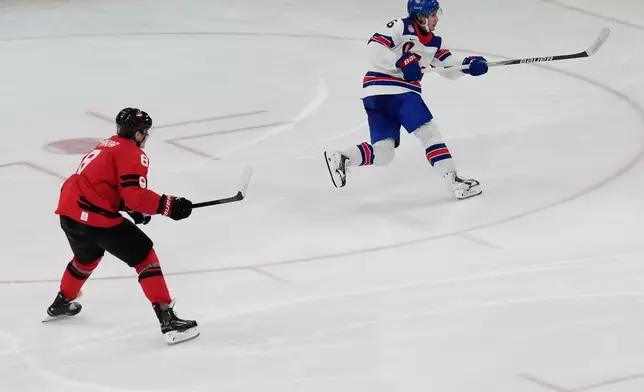 United States' Jack Hughes (86) takes a shot to score the winning goal in sudden death overtime against Canada during the men's ice hockey gold medal game at the 2026 Winter Olympics, in Milan, Italy, Sunday, Feb. 22, 2026. (AP Photo/Luca Bruno)