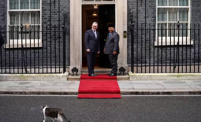 FILE - Britain's Prime Minister Keir Starmer welcomes President Prabowo Subianto of Indonesia to 10 Downing Street as they watch Larry the cat, Chief Mouser to the Cabinet Office, crossing the street in London, Tuesday, Jan. 20, 2026. (AP Photo/Alberto Pezzali, File)