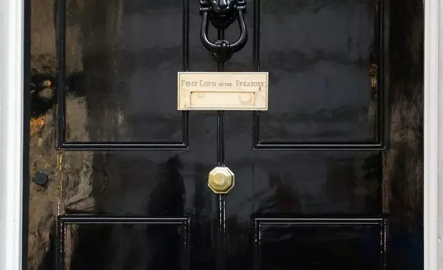 FILE - Larry the Cat waits outside number 10 Downing Street in London, Thursday Sept. 10, 2015. (AP Photo/Frank Augstein, file)