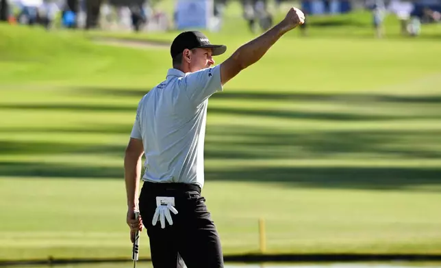 Justin Rose, of England, celebrates on the 18th green after winning the Farmers Insurance Open golf tournament Sunday, Feb. 1, 2026, at Torrey Pines in San Diego. (AP Photo/Denis Poroy)