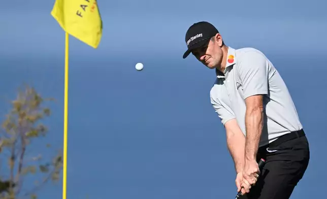 Justin Rose, of England, chips to the fourth hole of the South Course at Torrey Pines during the final round of the Farmers Insurance Open golf tournament Sunday, Feb. 1, 2026, in San Diego. (AP Photo/Denis Poroy)