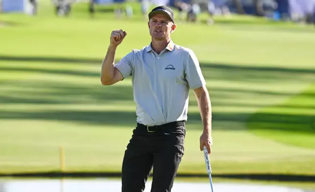 Justin Rose, of England, celebrates on the 18th green after winning the Farmers Insurance Open golf tournament Sunday, Feb. 1, 2026, at Torrey Pines in San Diego. (AP Photo/Denis Poroy)