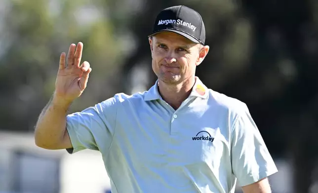 Justin Rose, of England, waves to the gallery on the 15th green of the South Course at Torrey Pines during the final round of the Farmers Insurance Open golf tournament Sunday, Feb. 1, 2026, in San Diego. (AP Photo/Denis Poroy)