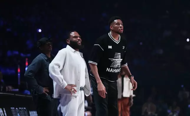 Coaches Giannis Antetokounmpo, right, and Anthony Anderson watch action during an NBA basketball's All-Star Celebrity Game Friday, Feb. 13, 2026, in Inglewood, Calif. (AP Photo/Jae C. Hong)