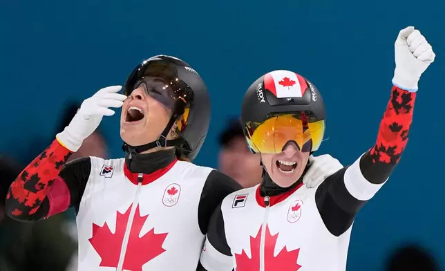 Team Canada's Valerie Maltais, left, and Ivanie Blondin, right, celebrate winning gold in the final of the women's team pursuit speedskating race at the 2026 Winter Olympics, in Milan, Italy, Tuesday, Feb. 17, 2026. (AP Photo/Ben Curtis)
