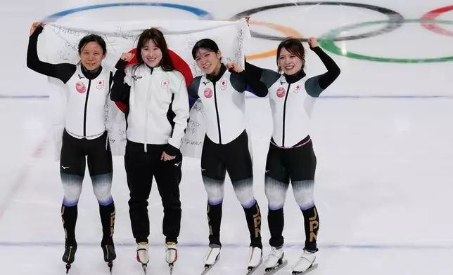 Team Japan with Momoka Horikawa, Ayano Sato, Miho Takagi, and Hana Noake, celebrate winning the bronze medal in the women's team pursuit speedskating race at the 2026 Winter Olympics, in Milan, Italy, Tuesday, Feb. 17, 2026. (AP Photo/Luca Bruno)