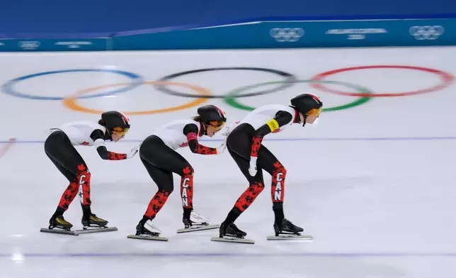 Team Canada with Ivanie Blondin, white armband, Valerie Maltais, red armband, Isabelle Weidemann, yellow armband, competes in the semifinal of the women's team pursuit speedskating race at the 2026 Winter Olympics, in Milan, Italy, Tuesday, Feb. 17, 2026. (AP Photo/Luca Bruno)