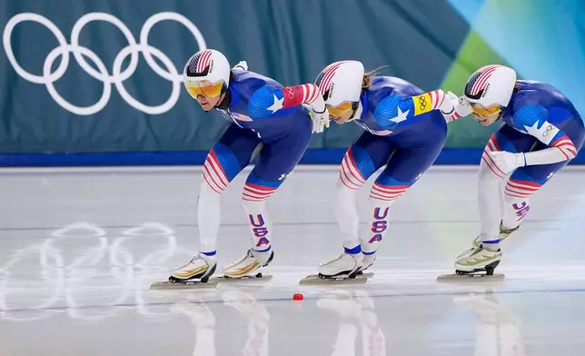 Team USA with Giorgia Birkeland, white armband, Brittany Bowe, red armband, Mia Manganello, yellow armband, competes in the semifinal of the women's team pursuit speedskating race at the 2026 Winter Olympics, in Milan, Italy, Tuesday, Feb. 17, 2026. (AP Photo/Ben Curtis)