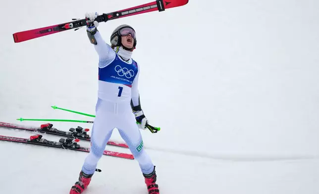 Brazil's Lucas Pinheiro Braathen celebrates winning an alpine ski, men's giant slalom race, at the 2026 Winter Olympics, in Bormio, Italy, Saturday, Feb. 14, 2026. (AP Photo/John Locher)