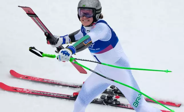 Brazil's Lucas Pinheiro Braathen celebrates winning an alpine ski, men's giant slalom race, at the 2026 Winter Olympics, in Bormio, Italy, Saturday, Feb. 14, 2026. (AP Photo/John Locher)