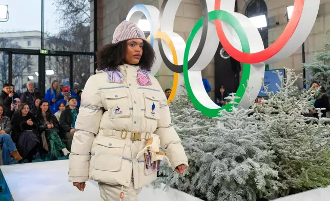 A model presents an outfit of the French National Olympic Committee, during a fashion show ahead of the 2026 Winter Olympics, in Milan, Italy, Wednesday, Feb. 4, 2026. (Xue Yuge/Pool Photo via AP)