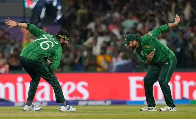 Pakistan's Usman Tariq, left, and Pakistan's captain Salman Agha celebrates the wicket of United States' Mohammad Mohsin during the T20 World Cup cricket match between Pakistan and the United States iin Colombo, Sri Lanka, Tuesday, Feb. 10, 2026. (AP Photo/Eranga Jayawardena)