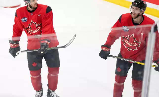FILE - Canada's Sidney Crosby and Connor McDavid skate together following 4 Nations Face-Off hockey practice in Brossard, Quebec on Monday, Feb. 10, 2025. Canada will face Sweden on February 12. (Christinne Muschi/The Canadian Press via AP, File)