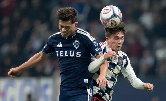 Vancouver Whitecaps' Sebastian Berhalter, left, and Real Salt Lake's Zach Booth (23) jump for the ball during the first half of an MLS soccer match in Vancouver, on Saturday, Feb. 21, 2026. (Ethan Cairns/The Canadian Press via AP)