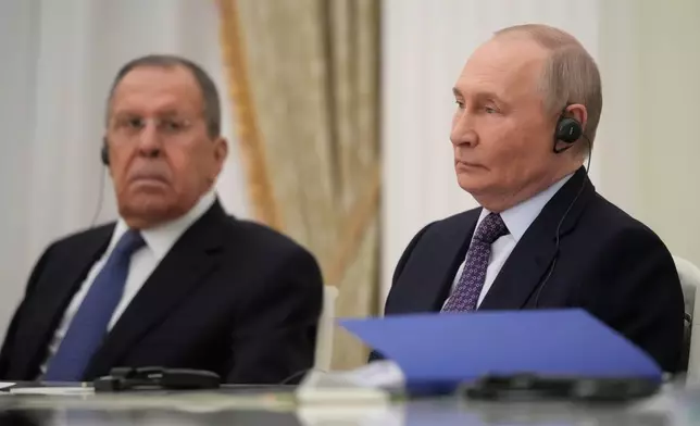 Russian President Vladimir Putin, right, and Russian Foreign Minister Sergey Lavrov listen to Cuban Foreign Minister Bruno Rodriguez Parrilla, during their talks at the Senate Palace of the Kremlin in Moscow, Wednesday, Feb. 18, 2026. (AP Photo/Pavel Bednyakov, Pool)