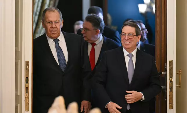 Russian Foreign Minister Sergey Lavrov, left, and Cuban Foreign Minister Bruno Rodriguez enter a hall during their meeting in Moscow, Russia, Wednesday, Feb. 18, 2026. (Hector Retamal/Pool Photo via AP)