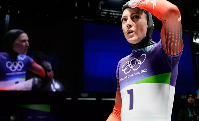 Austria's Janine Flock arrives at the finish during a women's skeleton run at the 2026 Winter Olympics, in Cortina d'Ampezzo, Italy, Friday, Feb. 13, 2026. (AP Photo/Alessandra Tarantino)