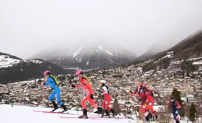 Italy's Alba de Silvestro, left, is followed by Austria's Johanna Hiemer, during a ski mountaineering mixed relay, at the 2026 Winter Olympics, in Bormio, Italy, Saturday, Feb. 21, 2026. (AP Photo/Rebecca Blackwell)