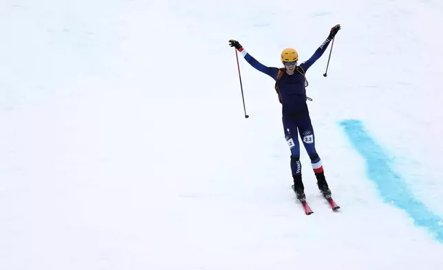 France's Thibault Anselmet celebrates winning a gold medal in a ski mountaineering mixed relay, at the 2026 Winter Olympics, in Bormio, Italy, Saturday, Feb. 21, 2026. (AP Photo/Gabriele Facciotti)