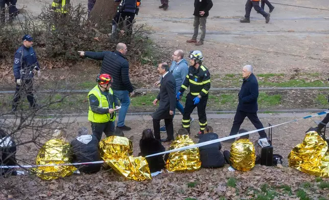 Mayor of Milan Giuseppe Sala, centre, arrives at the scene of a derailment on Line 9 in Milan, Italy, Friday, Feb. 27, 2026. (Stefano Porta/LaPresse via AP)