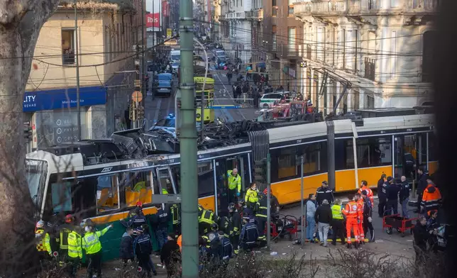 Rescuers and police officers work at the scene of a derailment on Line 9 in Milan, Italy, Friday, Feb. 27, 2026. (Stefano Porta/LaPresse via AP)
