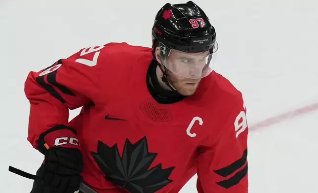 Canada's Connor McDavid wears the team captain's letter C on his jersey in place of the injured Sidney Crosby during the second period of a men's ice hockey semifinal game against Finland at the 2026 Winter Olympics in Milan, Italy, Friday, Feb. 20, 2026. (AP Photo/Carolyn Kaster)
