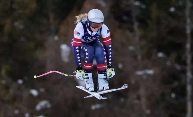 United States' Lindsey Vonn speeds down the course during an alpine ski, women's downhill official training, at the 2026 Winter Olympics, in Cortina d'Ampezzo, Italy, Friday, Feb. 6, 2026. (AP Photo/Marco Trovati)