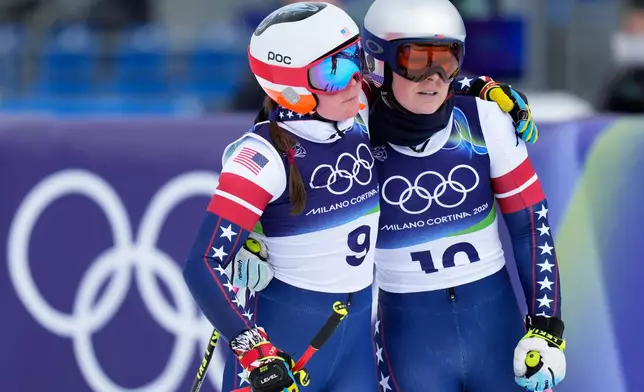 United States' Lindsey Vonn, right, and Breezy Johnson at the finish area during an alpine ski, women's downhill official training, at the 2026 Winter Olympics, in Cortina d'Ampezzo, Italy, Friday, Feb. 6, 2026. (AP Photo/Giovanni Auletta)