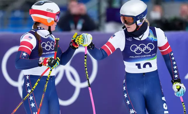United States' Lindsey Vonn, right, and Breezy Johnson at the finish area during an alpine ski, women's downhill official training, at the 2026 Winter Olympics, in Cortina d'Ampezzo, Italy, Friday, Feb. 6, 2026. (AP Photo/Giovanni Auletta)