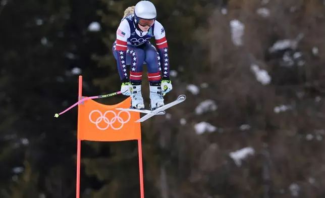 United States' Lindsey Vonn speeds down the course during an alpine ski, women's downhill official training, at the 2026 Winter Olympics, in Cortina d'Ampezzo, Italy, Friday, Feb. 6, 2026. (AP Photo/Marco Trovati)