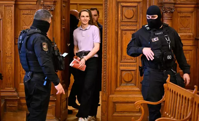Maja T., a German anti-fascist activist, accused of assaulting and injuring neo-Nazis in Budapest in Feb. 2023, who faces 24 years in prison, enters a court room in Budapest, Hungary, Wednesday, Feb.4, 2026, at the Budapest-Capital Regional Court. (AP Photo/Denes Erdos)
